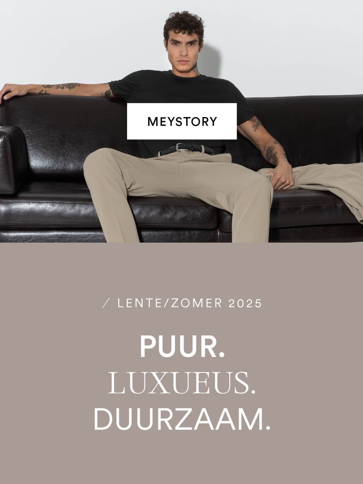 Getatoeëerd mannelijk model zit nonchalant op een zwarte leren bank en draagt een beige broek met een zwart T-shirt. Tekst toevoeging: Puur. Luxueus. Duurzaam.
